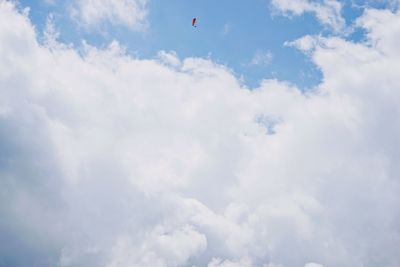 Low angle view of bird flying against sky