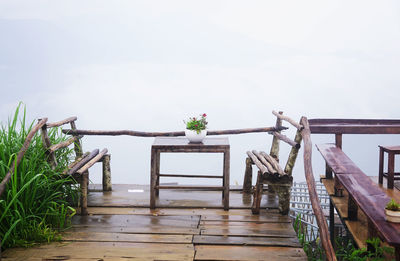 Coffee table and chairs set made by wood branches in the background of floating clouds 