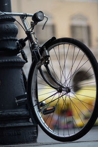 Close-up of bicycle parked against wall