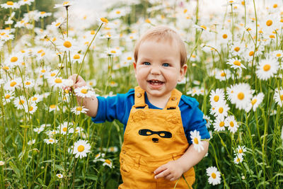 Portrait of cute girl standing on field