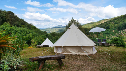 Tent on field against sky