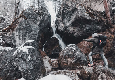 Low angle view of waterfall on rocks