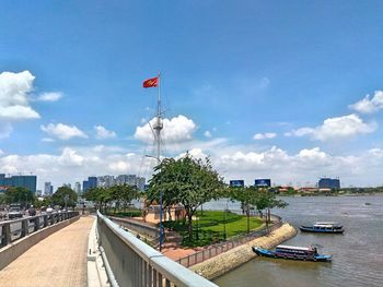 Scenic view of river amidst city against sky