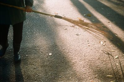 Low section of man walking on road