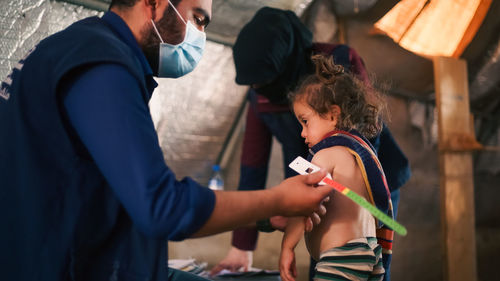 Midsection of doctor examining patient