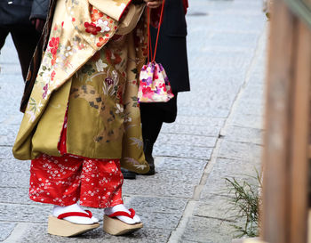 Low section of woman wearing shoes