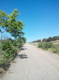 Country road against clear sky