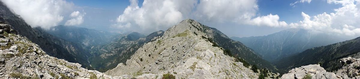 Panoramic view of mountain range against cloudy sky