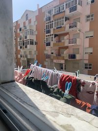 Clothes drying on table by buildings in city