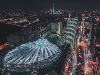 High angle view of city lit up at night