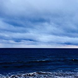 Scenic view of sea against cloudy sky