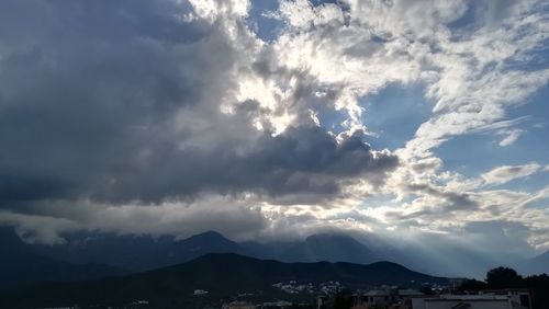 Scenic view of storm clouds over mountains