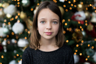 Portrait of girl against christmas tree