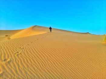 Walking on sand dunes on desert