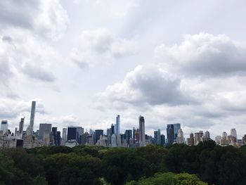 View of cityscape against cloudy sky