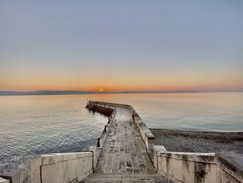 Pier in sea against sky