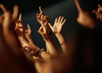 Midsection of woman with arms raised