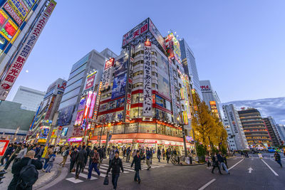 Low angle view of illuminated building against blue sky