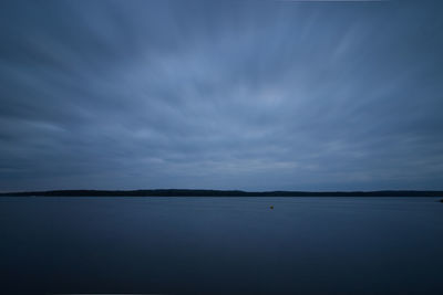 Scenic view of sea against sky at dusk