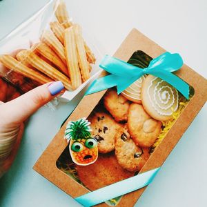 High angle view of person holding food on table