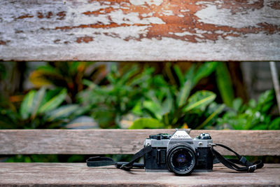 Close-up of camera on table against wall