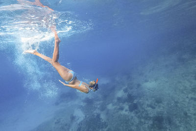 Full length of woman snorkeling under sea