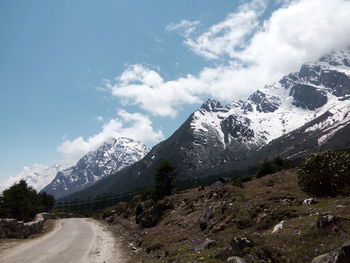 Scenic view of mountains against cloudy sky