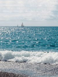 Sailboat in sea against sky