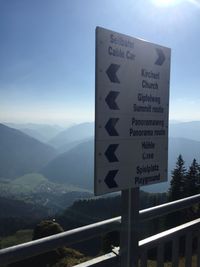 Road sign against sky