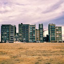 Modern buildings against cloudy sky