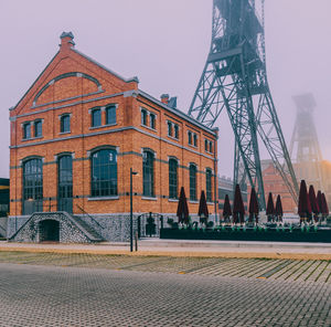 Buildings in city against clear sky