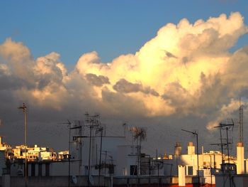 Buildings against cloudy sky