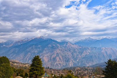 Scenic view of mountains against cloudy sky