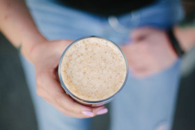 Close-up of hand holding  cold coffee glass