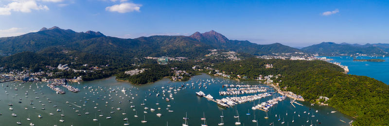 High angle view of city by sea against sky