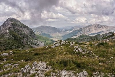 Scenic view of mountains against cloudy sky