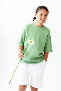 Portrait of boy standing against white background