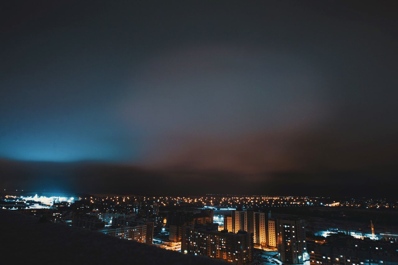 ILLUMINATED CITYSCAPE AT NIGHT