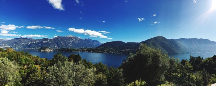 Panoramic view of lake and mountains against blue sky