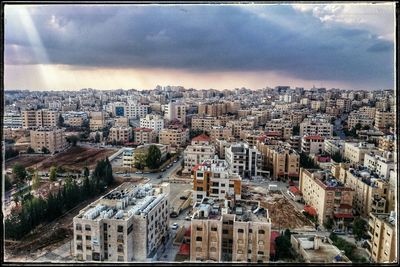 Cityscape against cloudy sky