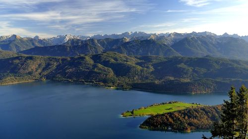 Scenic view of lake and mountains against sky