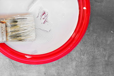 High angle view of paintbrushes in bowl on table