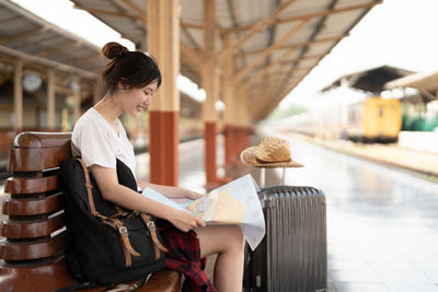 Side view of woman sitting on chair
