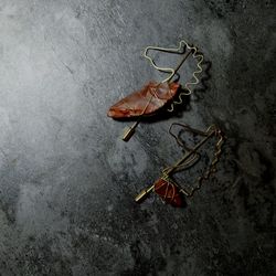 High angle view of dry leaf on metal table
