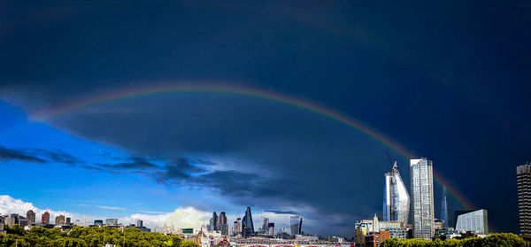 Rainbow over city buildings