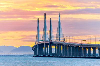 View of bridge over sea during sunset