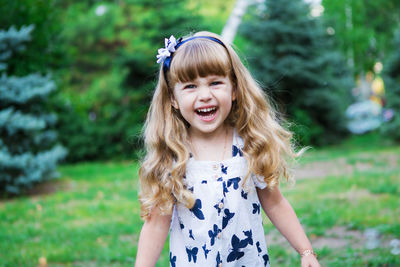 Happy girl smiling against plants