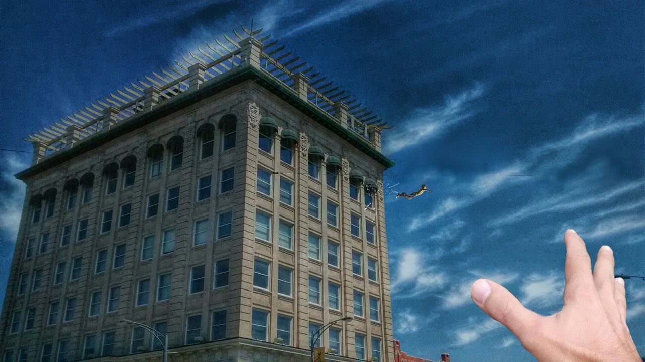building exterior, sky, architecture, low angle view, built structure, person, cloud - sky, part of, cloud, cloudy, cropped, unrecognizable person, outdoors, blue, day, city, building
