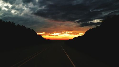 Scenic view of road against cloudy sky