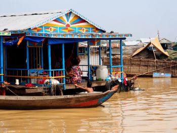 People in boat against sky